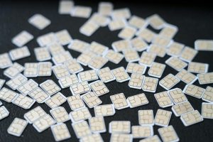 pile of sim cards on dark surface in studio